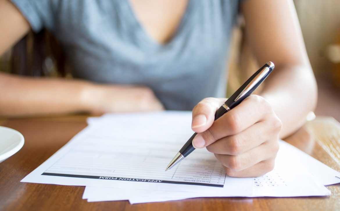 Close-up of woman filling application form