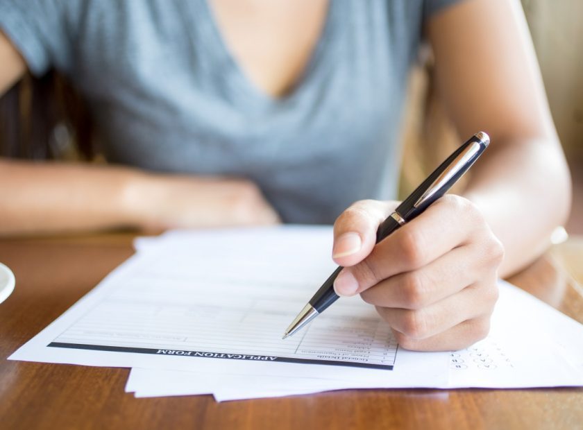 Close-up of woman filling application form